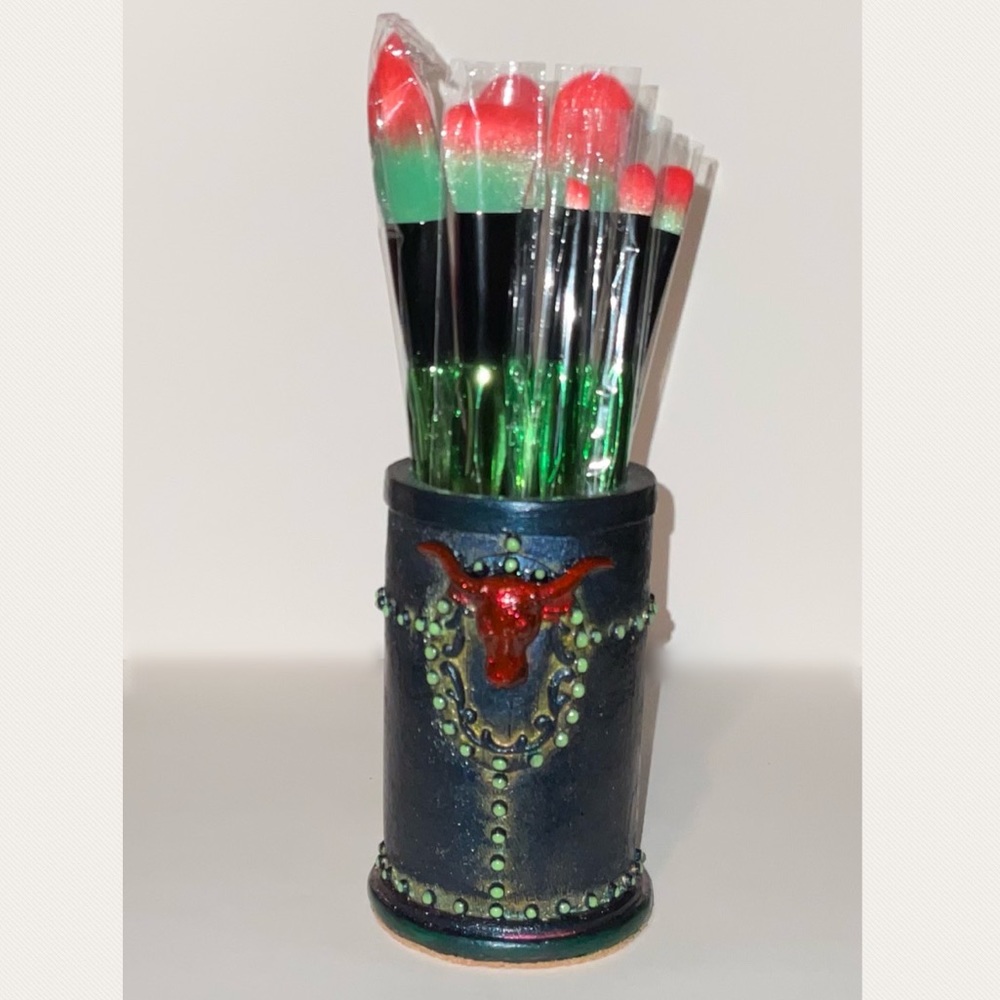 Seven piece make up brush sent with container.